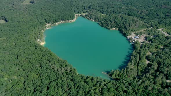 Beautiful blue-green lake in the middle of the forest. Water color of a sea wave