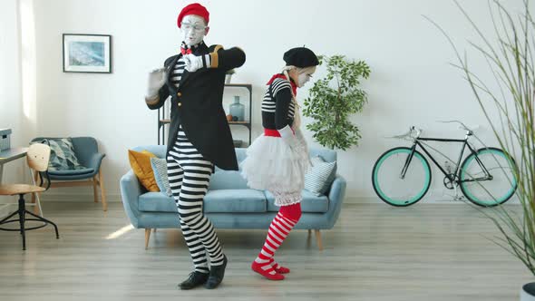 Slow Motion of Man and Woman Mimes Dancing and Having Fun Indoors in Apartment alt