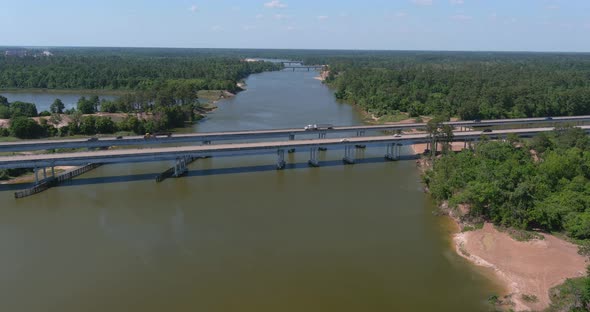 Aerial of cars driving on bridge that crosses over the San Jacinto River in Houston, Texas alt