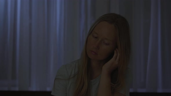 A Woman at Night Turns on a Meditation Relaxation Application to Relax Before Going to Bed alt
