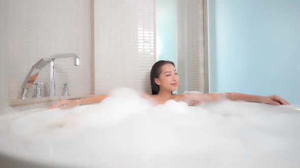 Young asian woman relax in bathtub