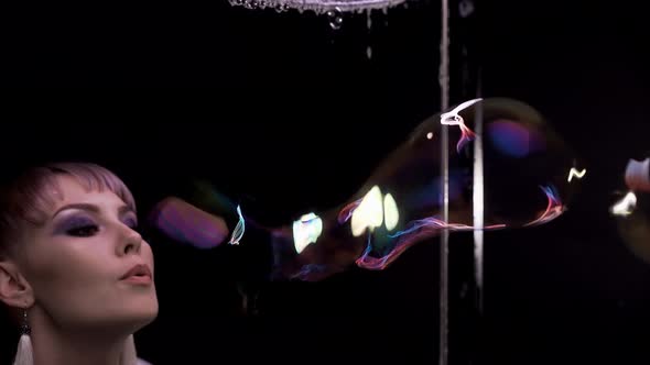 Closeup Pretty Girl Does Tricks with Soap Bubbles She Blows a Lot of Bubbles Through the Soap alt