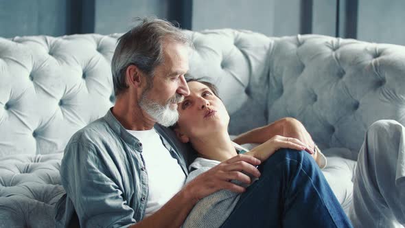 Elderly Couple Sitting Floor alt