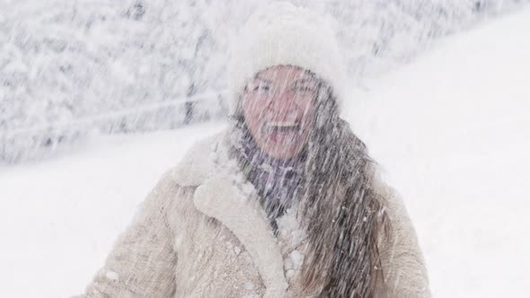 Young Beautiful Woman is Spinning and Someone is Sprinkling Snow on Her alt