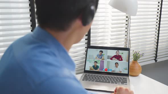 Asian businessman use laptop computer video call for meeting and brainstorm with office colleagues. alt