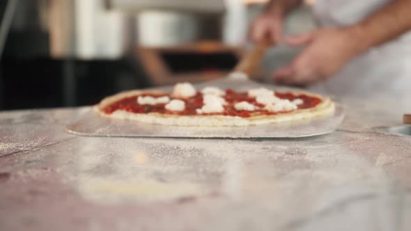 Italian Chef Making Margaritta Pizza with Tomato Sause and Mozzarella Traditional Food in Italy High alt