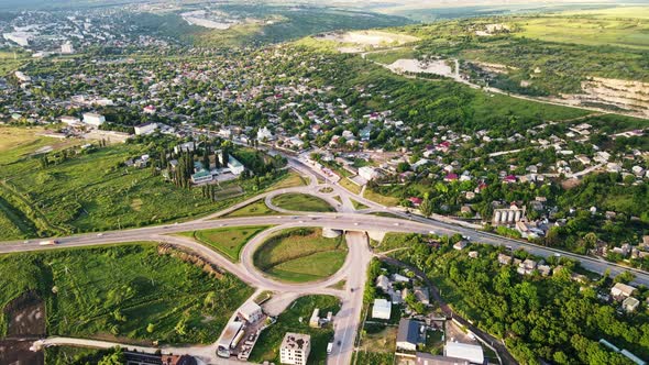Aerial drone view of a village and road with cars, greenery, Moldova alt