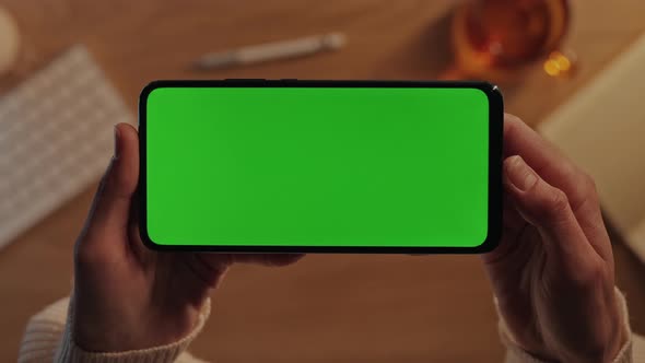 Close Up of Smartphone with Green Screen in Female Hands alt