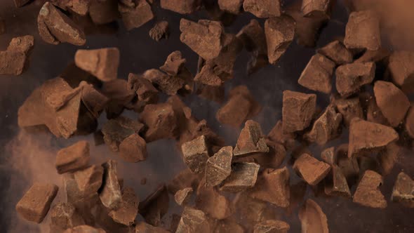 Super Slow Motion Shot of Flying Raw Chocolate Chunks and Cocoa Powder at 1000 Fps alt