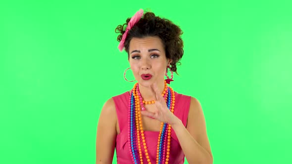 Girl Screams Calling Someone on a Green Screen at Studio alt