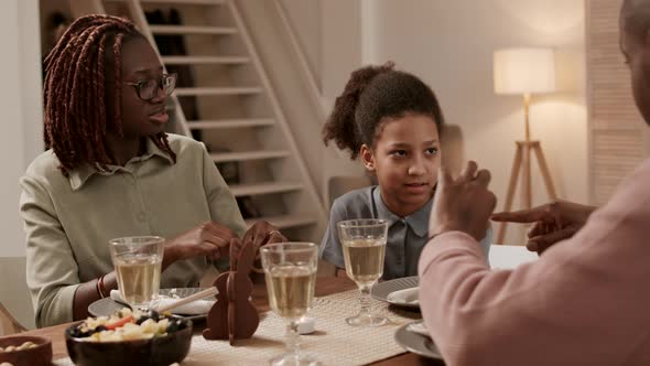 Girl Listening to Parents at Dinner alt