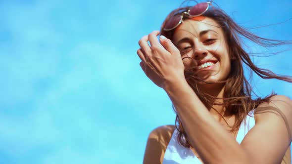Super Slow Motion Close Up Portrait of Young Joyful Girl Shaking Flying Hair Looking Down at Camera alt