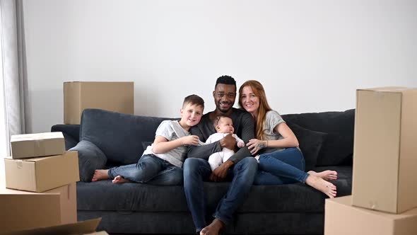 Happy Multiracial Family Moved in a New House alt