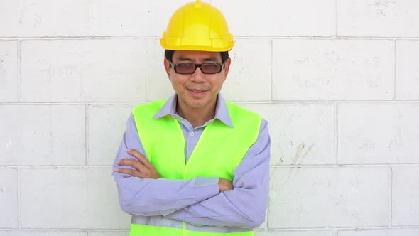 Asian male worker smiling and looking at camera