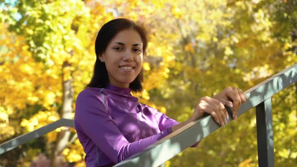 Cheerful Black Girl in Sportswear Posing Against Yellow Trees alt