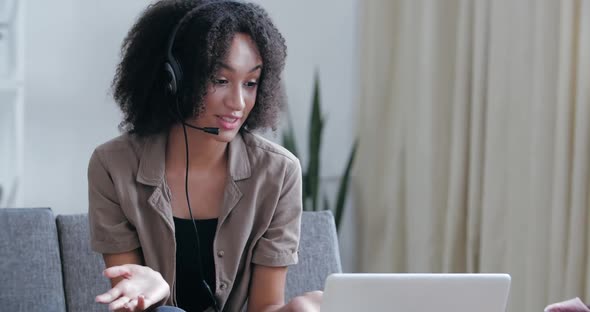 Young Busy Active Girl Freelancer Sits at Home in Office on Couch, Uses Laptop Webcam To Communicate alt