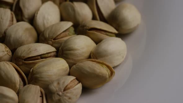 Cinematic, rotating shot of pistachios on a white surface - PISTACHIOS 017 alt