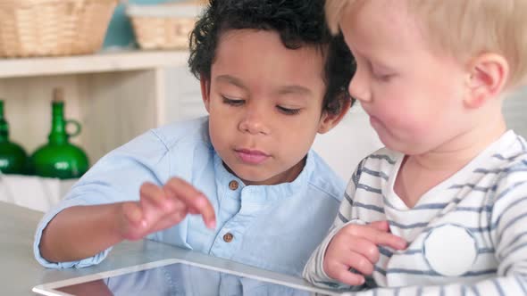 Mixed-Raced Little Boys Surfing the Net on Digital Tablet