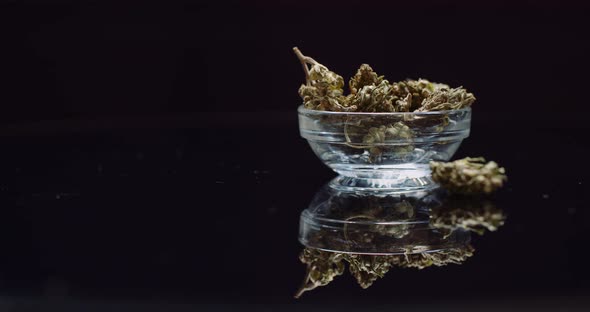 Cannabis Drugs Concept - Dry Marihuana in Small Bowl Rotating alt