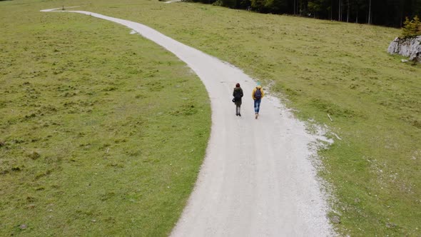 Couple hiking in Parco Naturale dei Laghi di Fusine, Italy alt