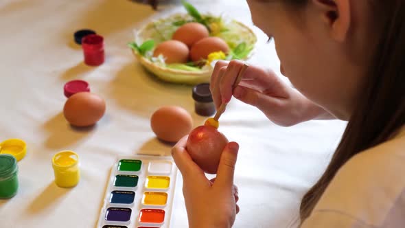 Child Girl Having Fun During Painting Eggs for Easter in Spring Time at Home alt