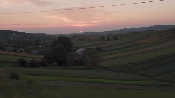 View From Window Highspeed Train on Landscape of Nature Field and Forest on Evening Dusk Sky Sunset alt