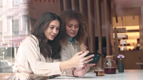 Two Friends Making Selfie in Restaurant alt