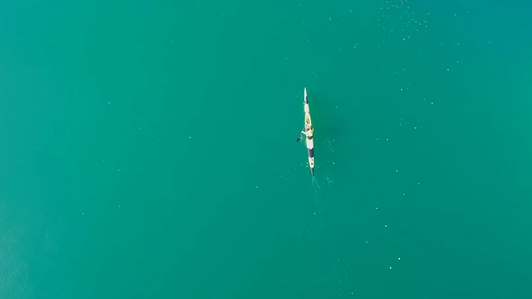 A kayaker paddles in a scenic mountain lake alt