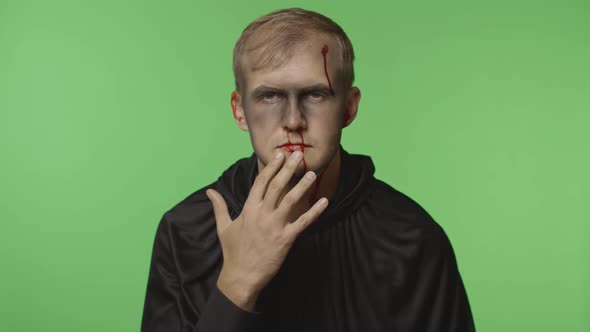 Man Executioner Halloween Makeup and Costume. Guy with Blood on His Face alt