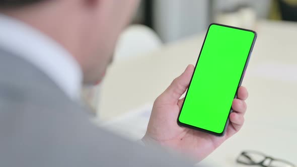 Businessman Using Smartphone with Green Chroma Screen alt