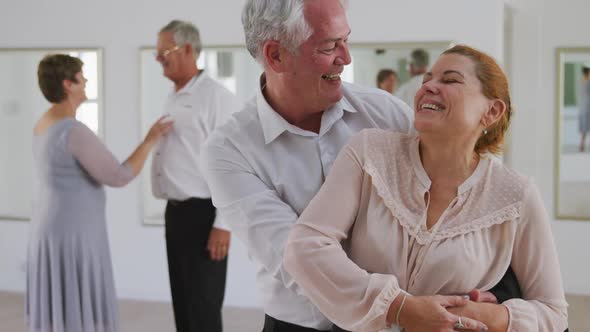Caucasian senior couple spending time together in a ballroom alt