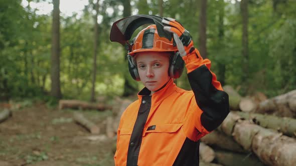 Portrait of a Female Logger Standing in the Forest a Young Specialist Woman in Protective Gear alt