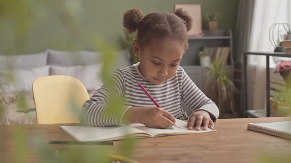 Happy Girl Drawing at Home alt