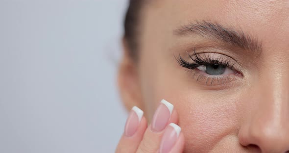 Closeup of View Half Face Young Girl Touching Her Face alt