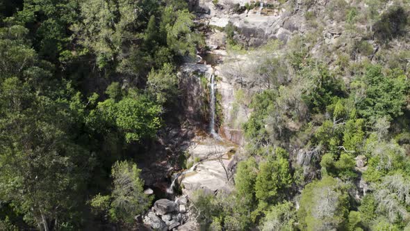 People enjoying the natural pools at Fecha de Barjas waterfall, Peneda-Gerês National Park.
