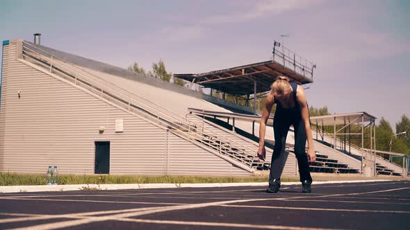 Young Girl Sporty Physique at the Stadium alt