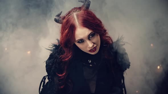 Ritual of Occultism or Esoterics Concept. Red-haired Girl Witch with Black Horns Sitting on Floor in alt