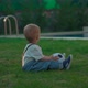 Toddler Sits on Soft Grass Throwing Soccer Ball to Mother - VideoHive Item for Sale