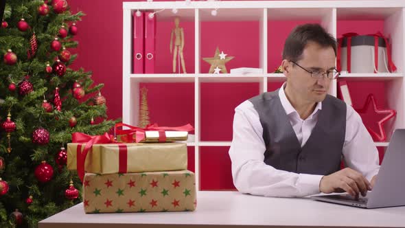 Gift Box Arrives at Supermarket Cart on Table Desk in Christmas Decorated Office