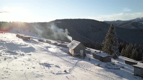 Flying Over Log Cabin Hut With Smoke Coming Out of a Chimney  alt