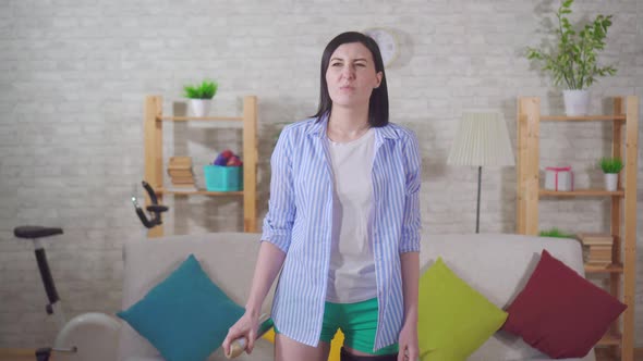 Disappointed Woman Housewife Uses a Spray Freshener for the Air alt