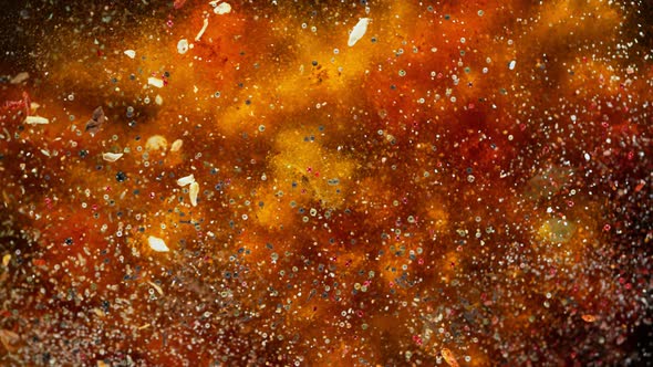Super Slow Motion Shot of Colorful Seasoning Explosion on Black Background at 1000Fps alt