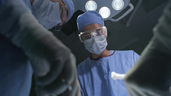 Surgeons Suturing Incision alt