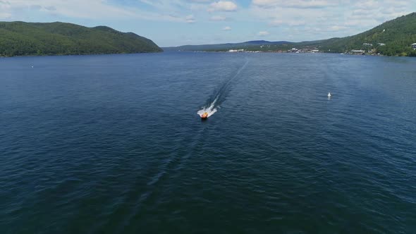 Aerial Drone Top View of Motor Boat Sailing on Lake Baikal. Speedboat on River Water in Bay.
