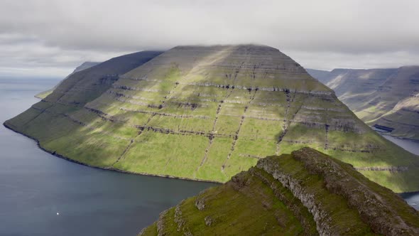 Drone Panning From Klakkur Mountain To Coastline And Sea alt