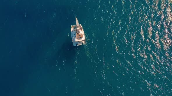 Aerial View. Large Sailing Catamaran in the Open Sea. alt