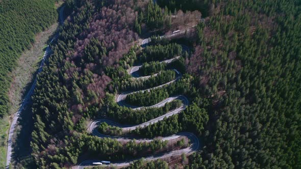 Top View Of The Curvy Road Of Bratocea Pass In Romania. aerial alt