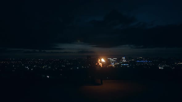 Young Blond Male Does Fire Show in the Middle of the Night Breathes Out Fire Making Fireballs alt