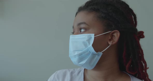 Close Up Portrait of Young African Woman in Medical Mask alt