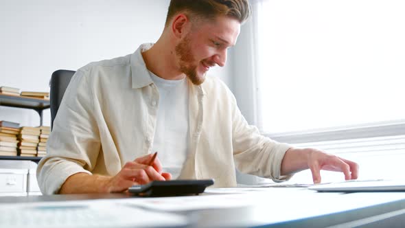 Bearded guy experienced accountant summarizes income comparing invoice receipts alt